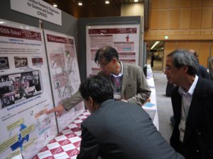 CROSS-Tokai staff speak to conference participants at the exhibitor's booth