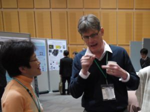 CROSS-Tokai staff speak to conference participants at the exhibitor's booth